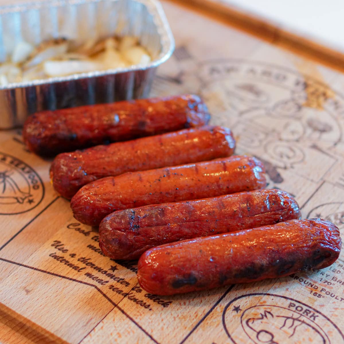 Grilled Australian sausages on a cutting board.