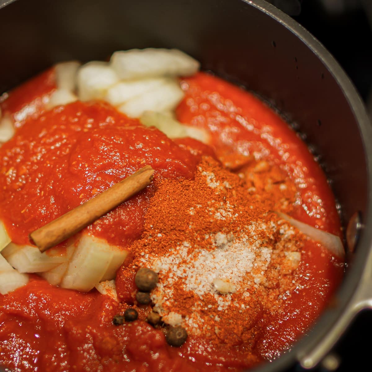 Making homemade ketchup in a pot on the stove.