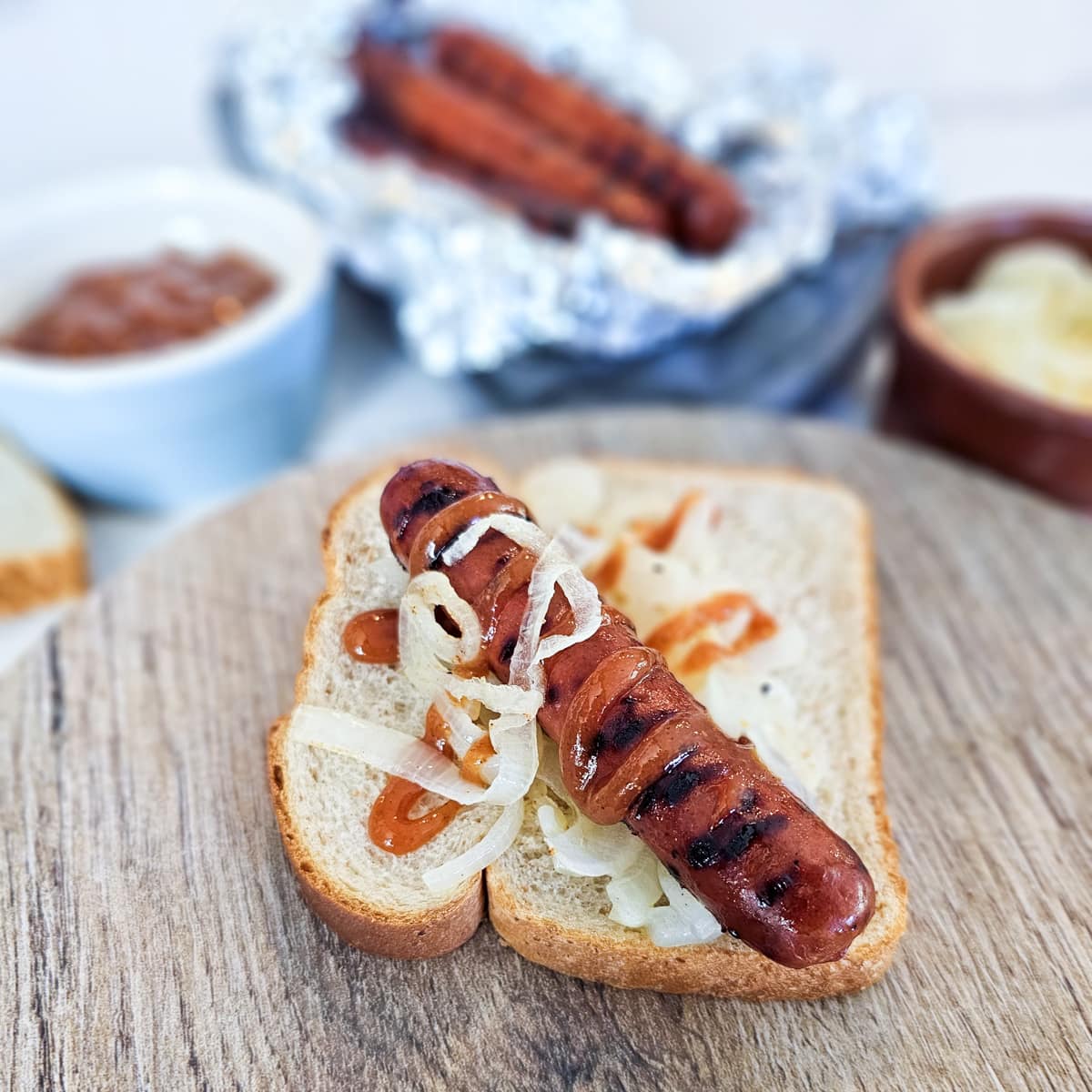 Aussie sausage sizzle topped with grilled onions and spicy homemade ketchup.