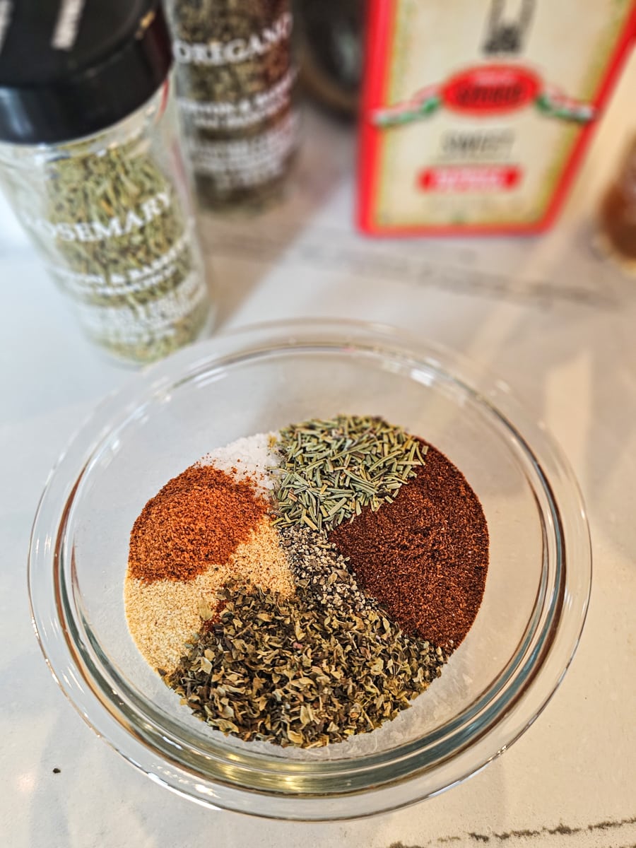 Assorted spices in a bowl for homemade Baltimore pit beef seasoning.