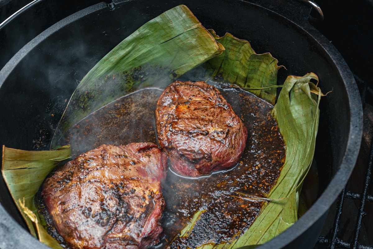 Braising the beef cheeks in a Dutch oven on a Big Green Egg.