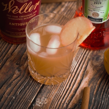 Spiked apple cider cocktail with bourbon, served on the rocks.