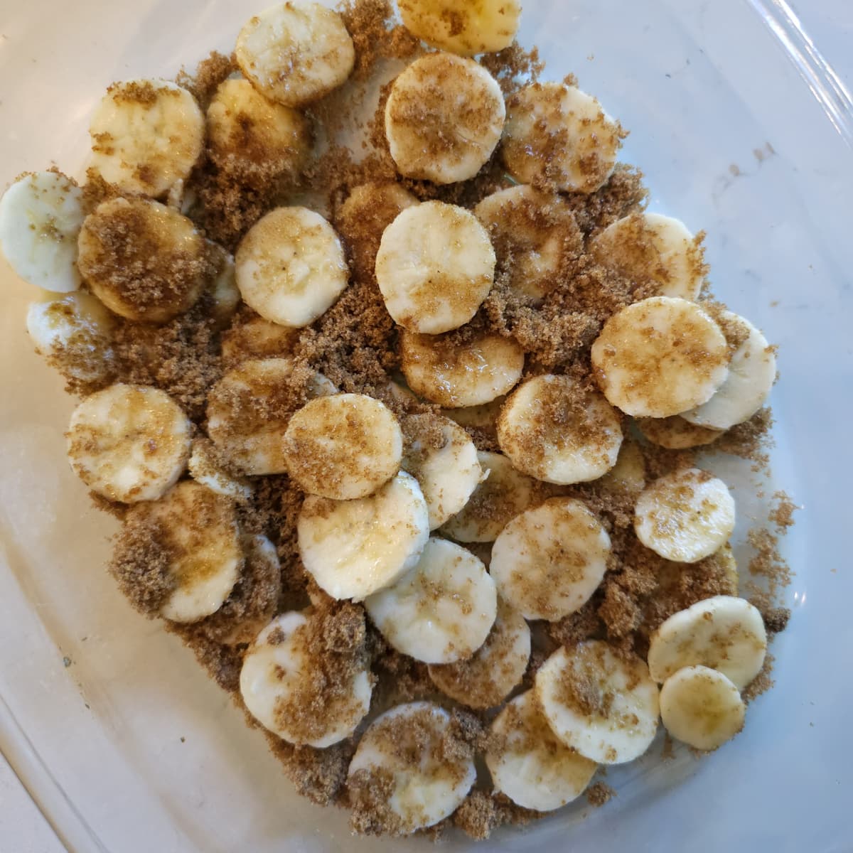 Slices of banana covered with brown sugar.