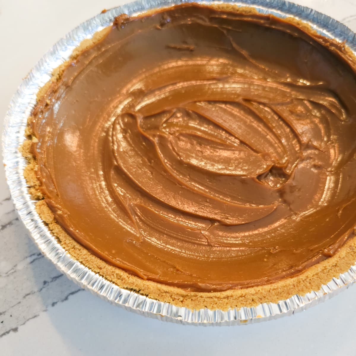 Dulce de leche spread into a Graham cracker crust.