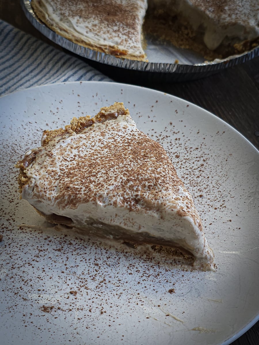 Slice of British banoffee pie on a white plate.