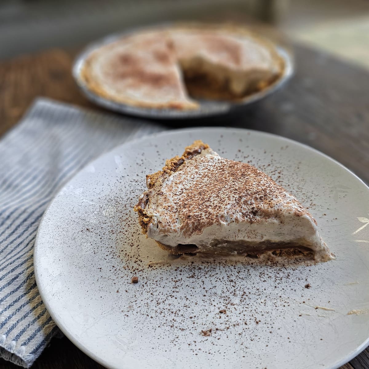 Traditional Banoffee pie on a white plate.