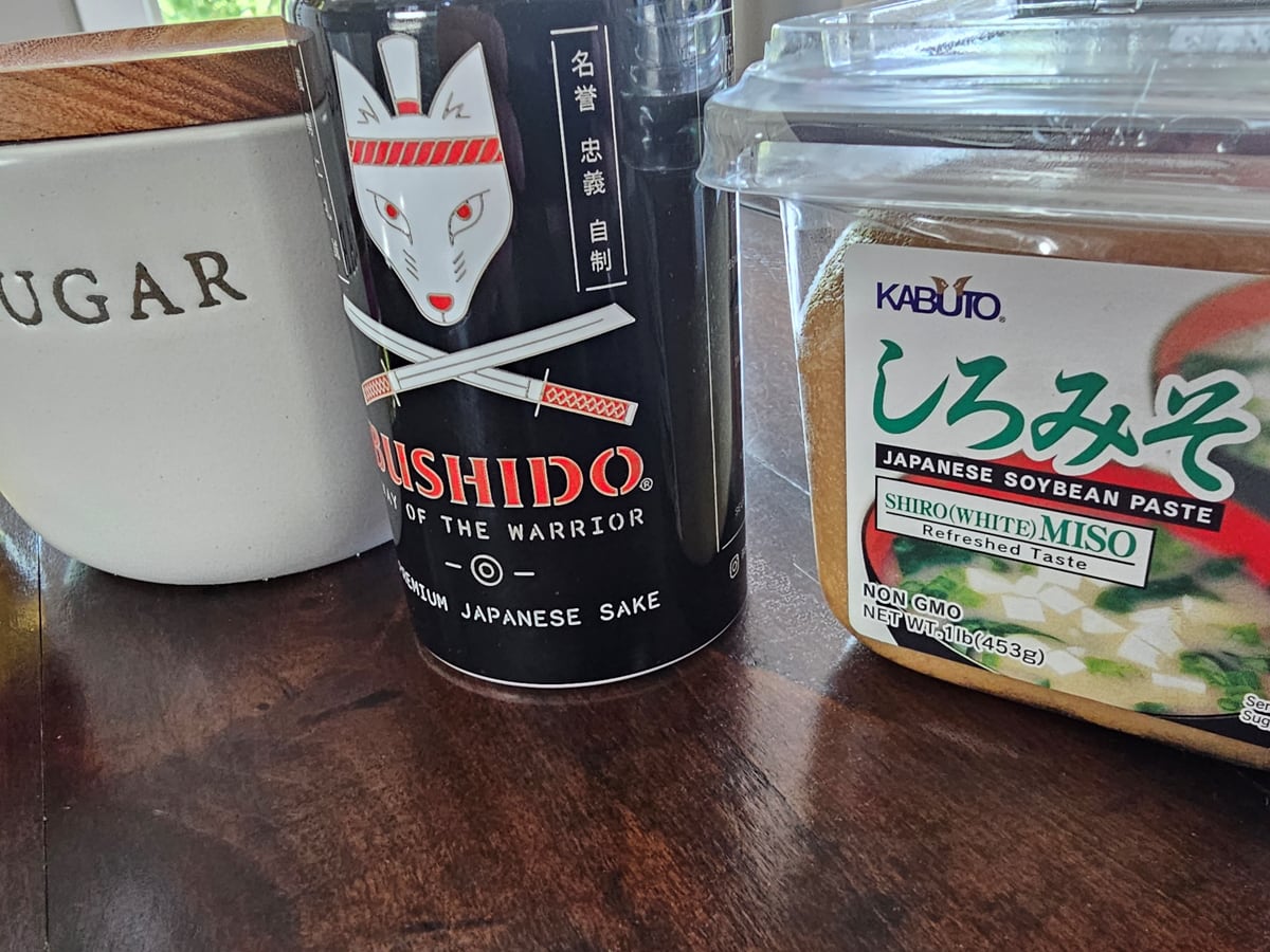 Miso, sugar, and sake on a countertop.