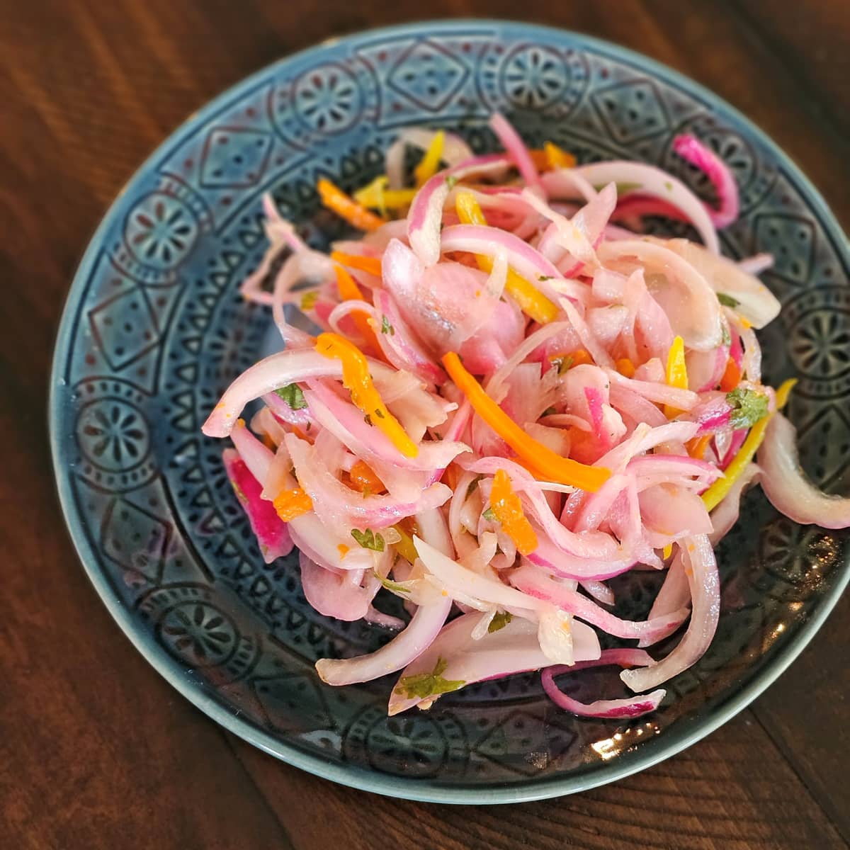 Sliced bell peppers and onions on a plate.