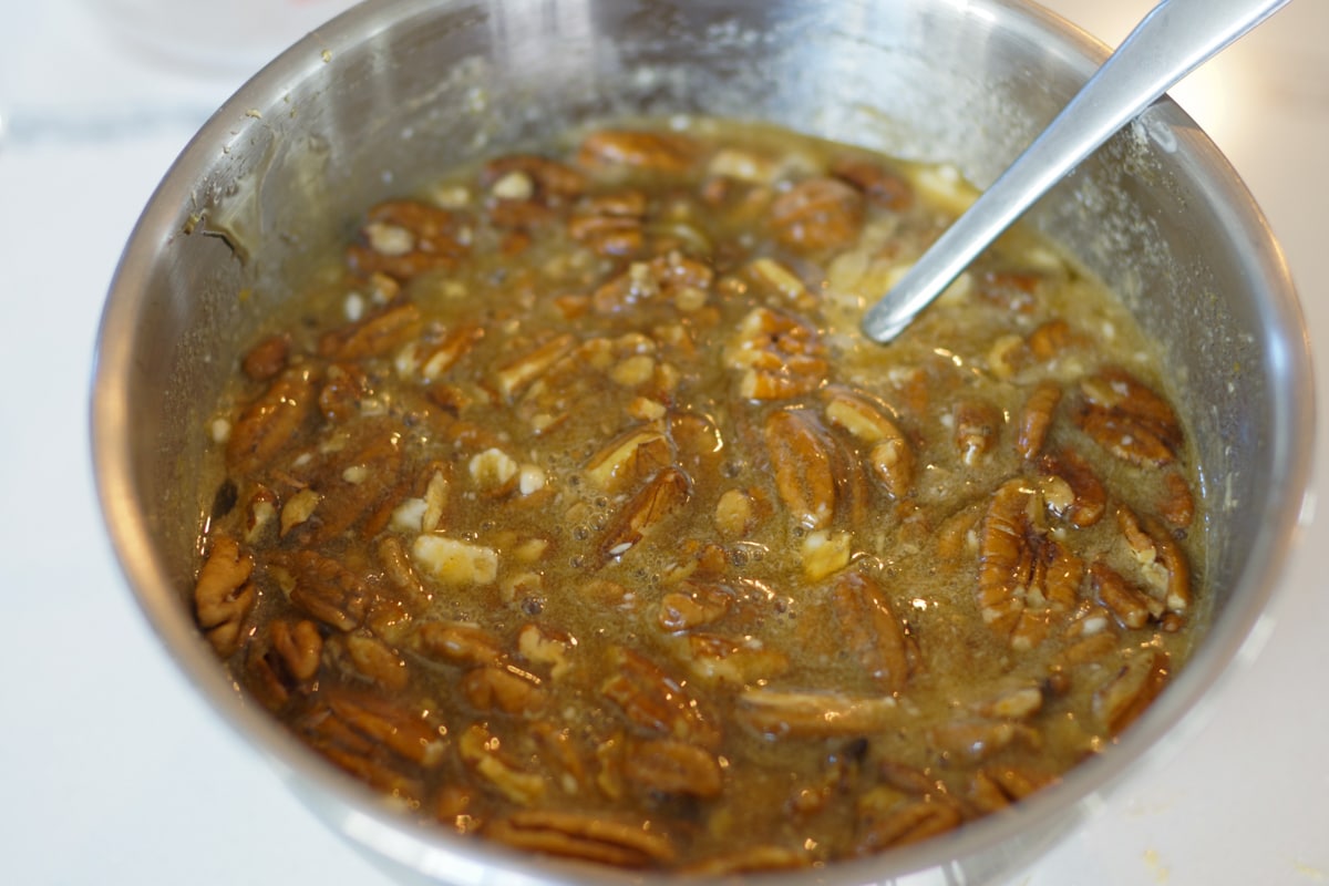 Pecans being added to the pie filling.