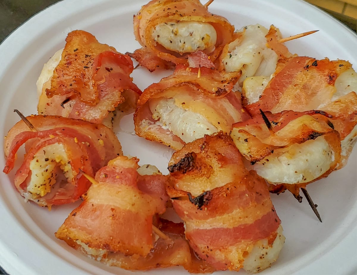 Plate of grilled bacon wrapped halibut bites.