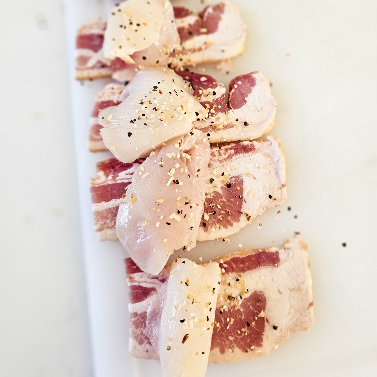 Bacon wrapped halibut cheeks seasoned with BBQ seasoning.