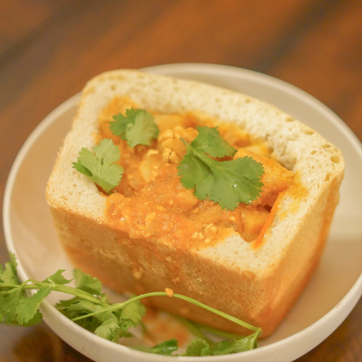 Bread filled with Durban style chicken curry.
