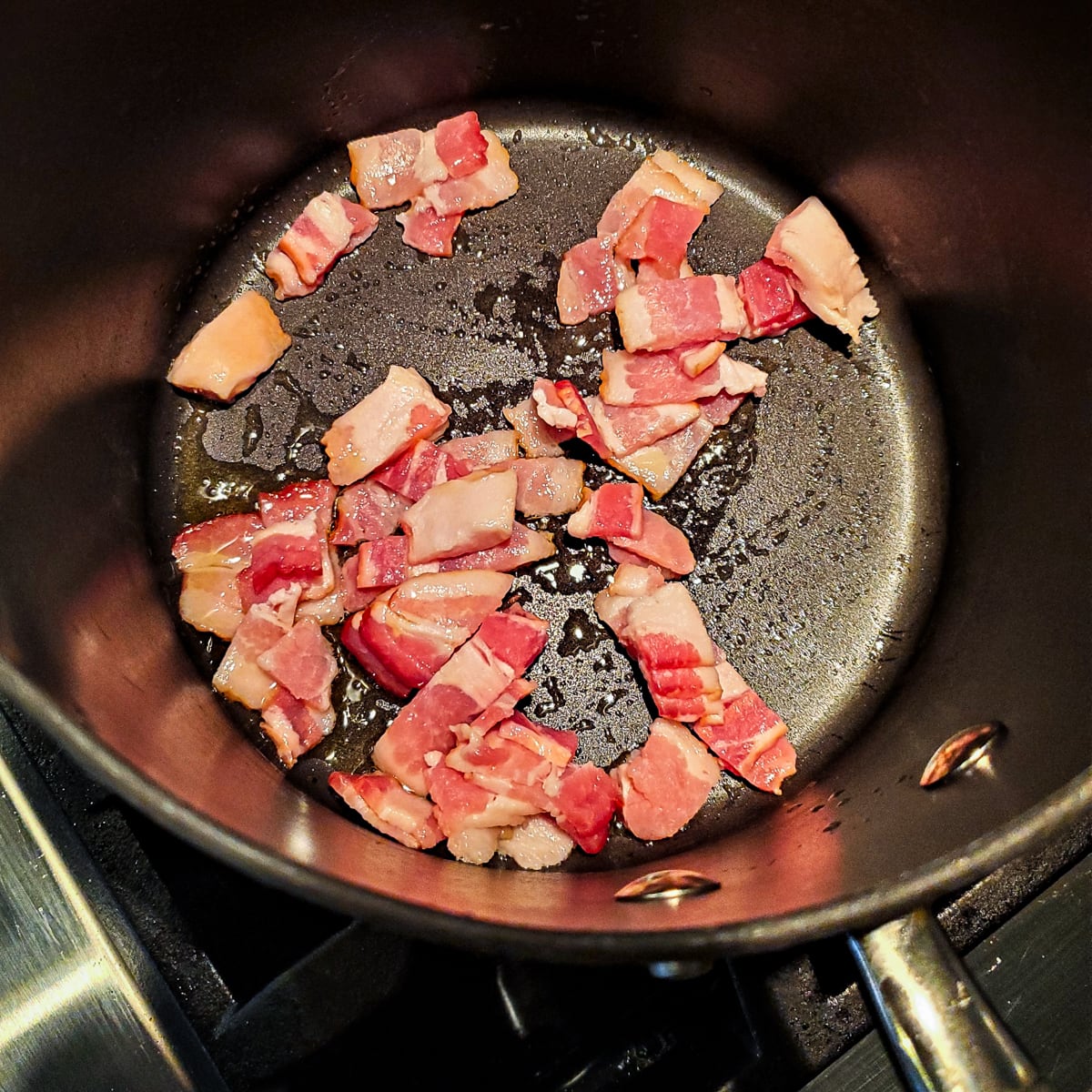 Bacon browning in a pan.
