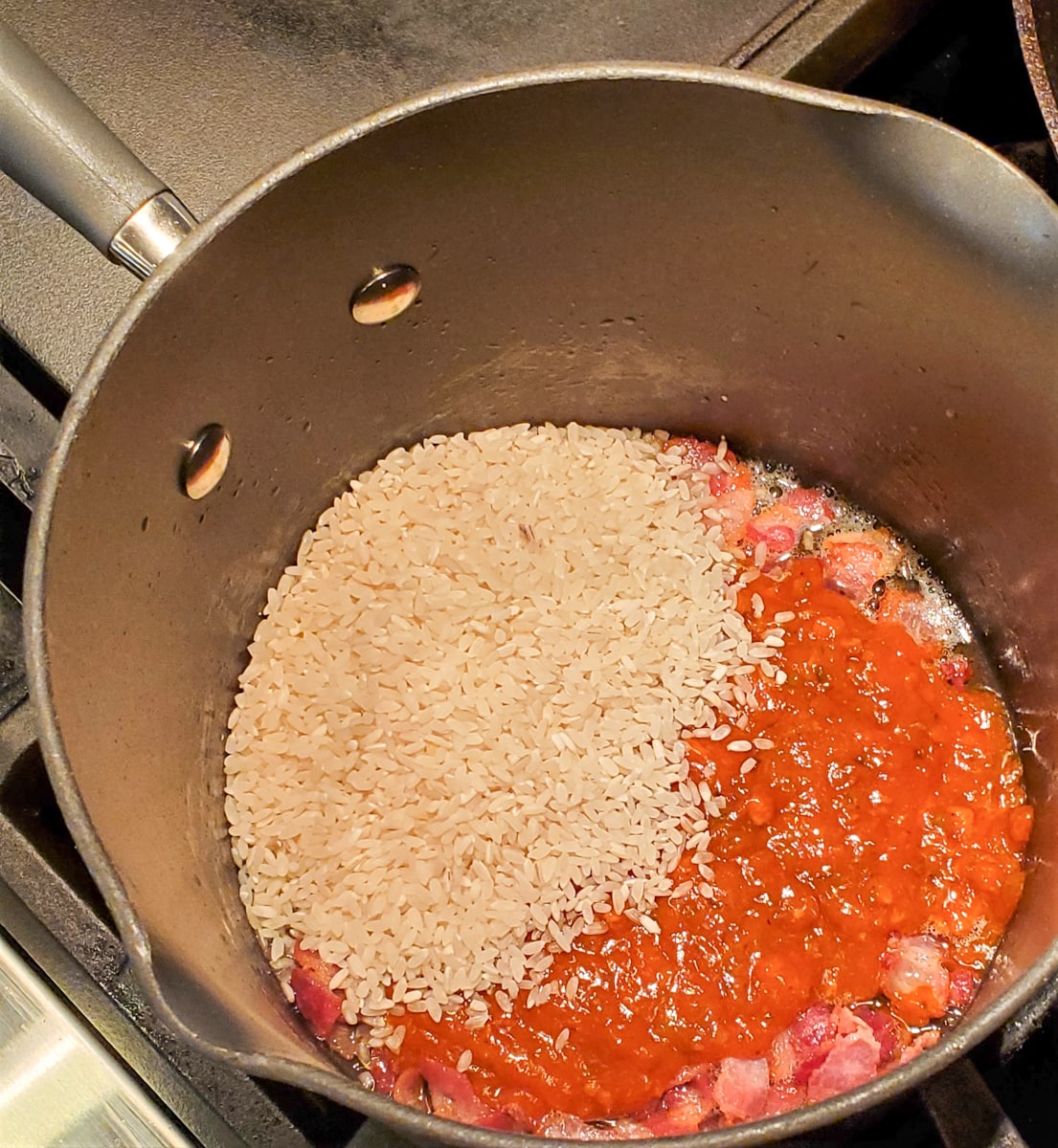 Rice cooking with sofrito and bacon.