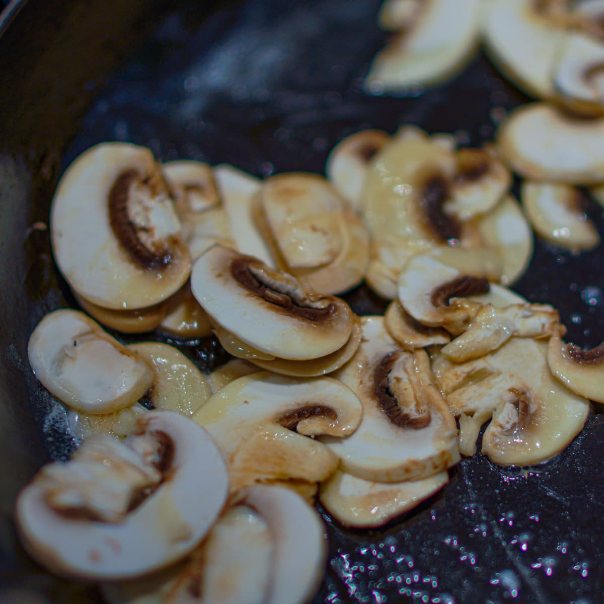 Mushrooms cooking in butter.