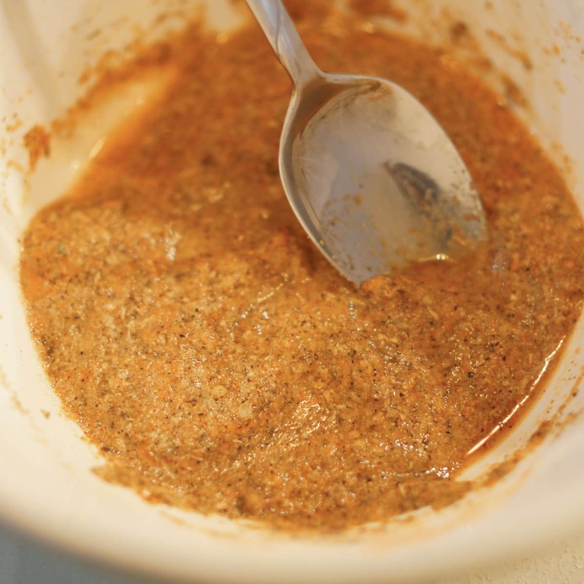 Spices mixed with water in a bowl.