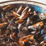 Croation style mussels in a large pan.