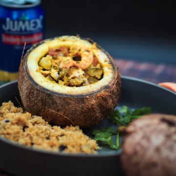 Coconut stuffed with curry vegetables and shrimp.