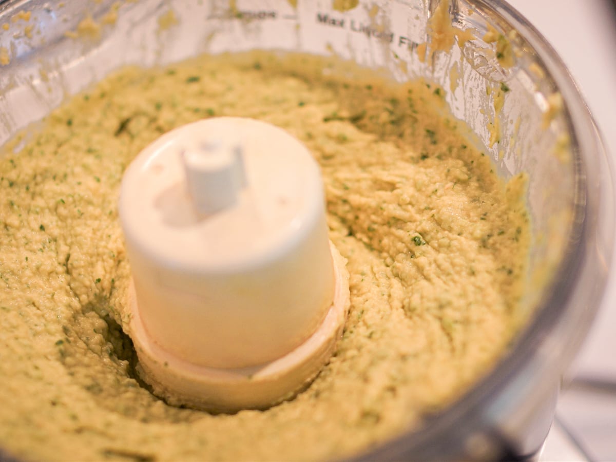 Making jalapeno hummus in a food processor.