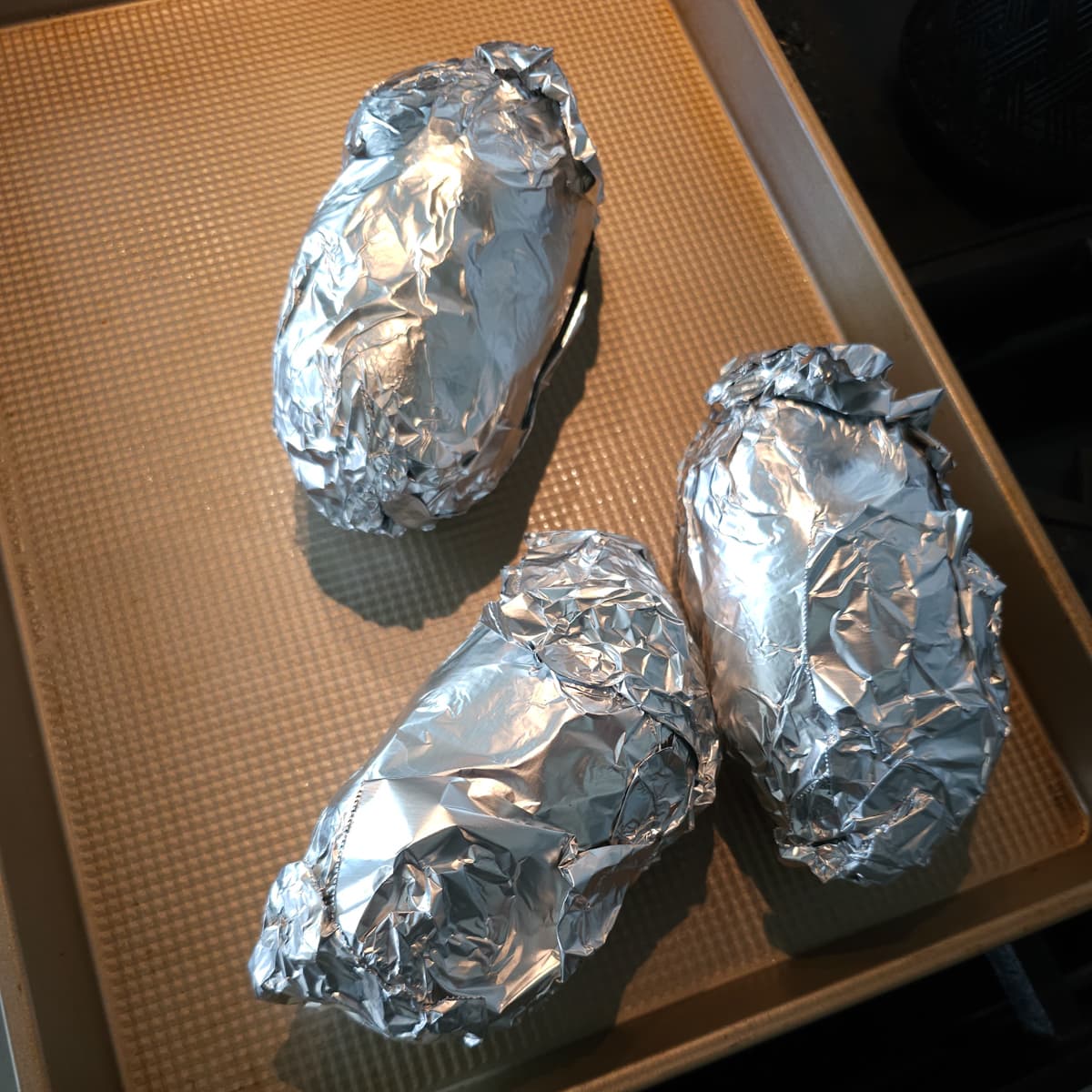 Potatoes wrapped in foil.