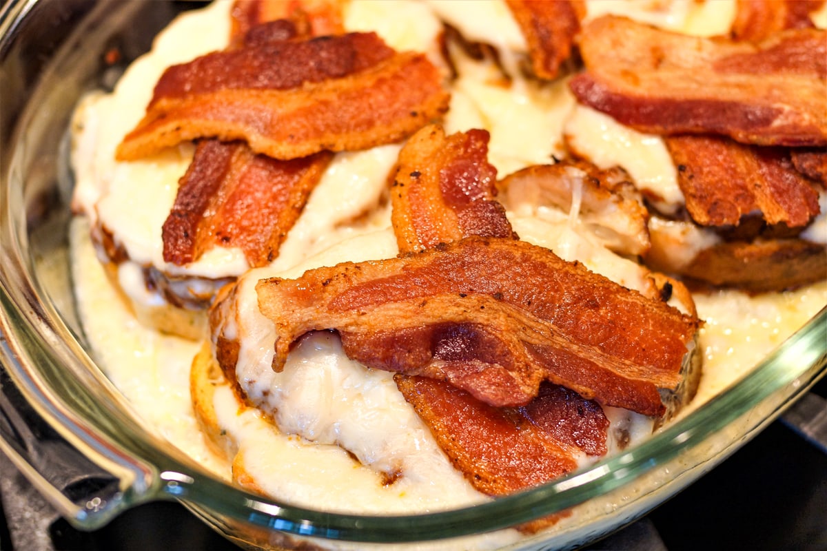 Bacon topped Hot Brown turkey sandwiches.