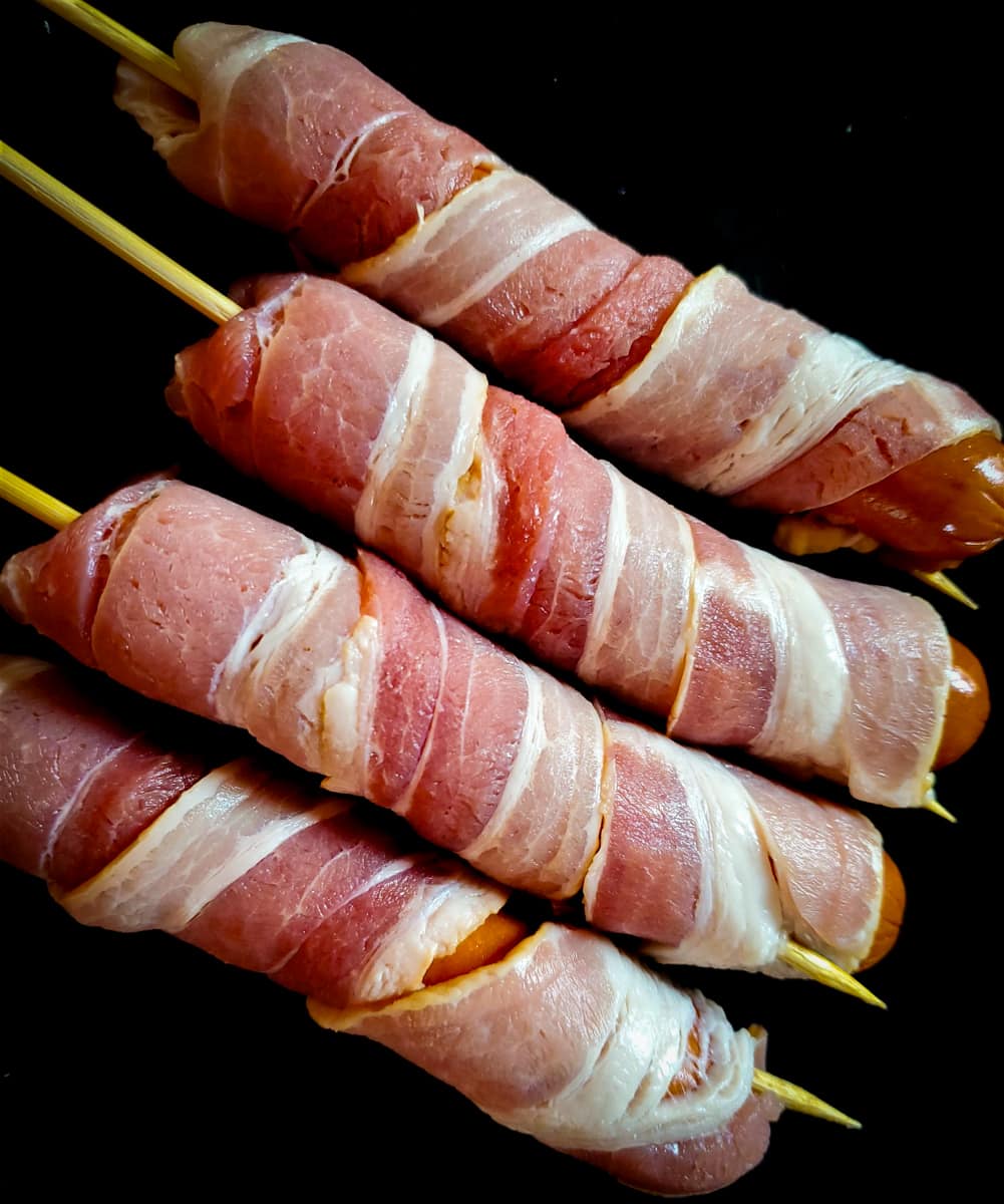 Beef hotdogs wrapped in bacon.