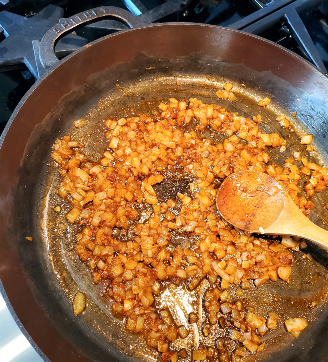 Onion and spices in a skillet.