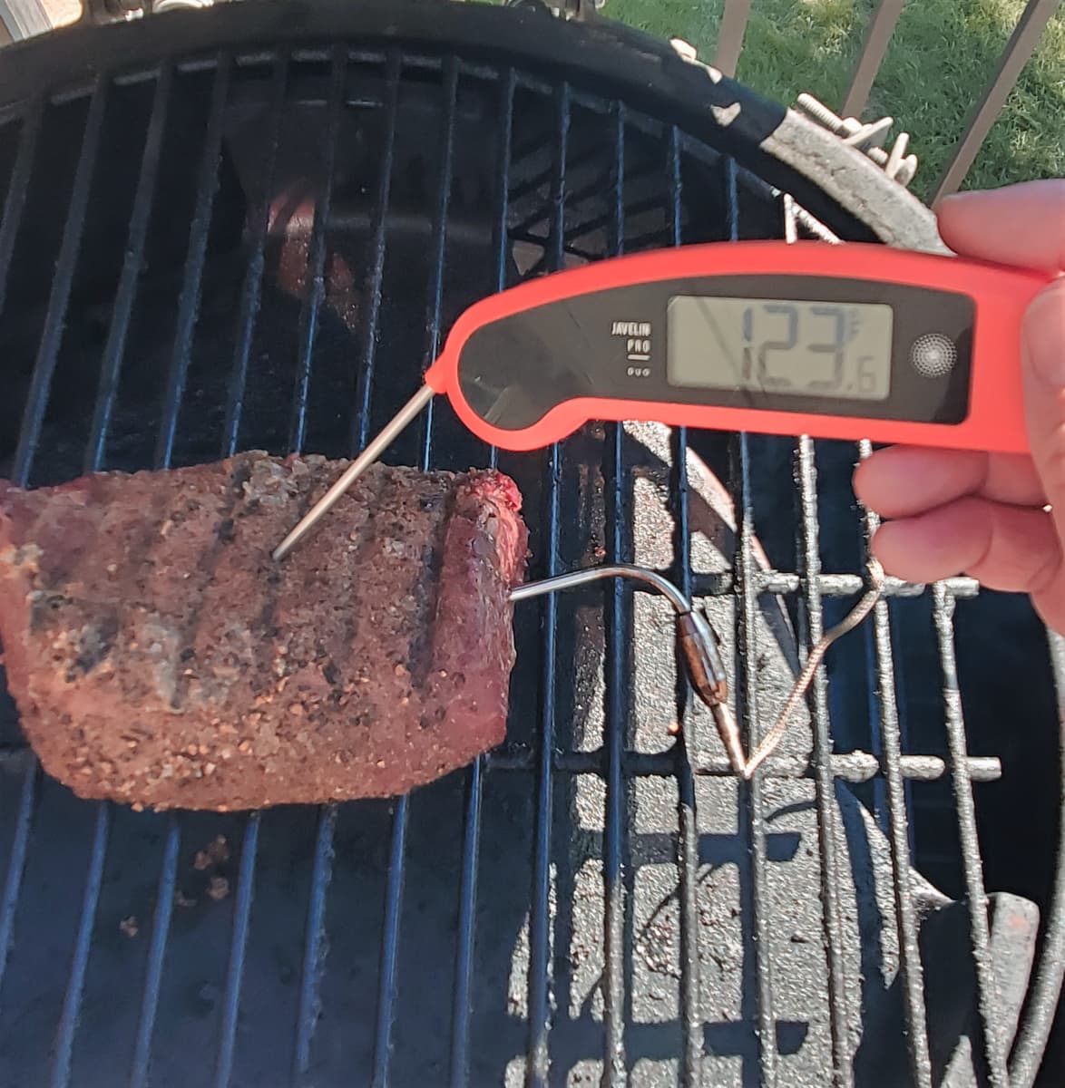 Checking the temp of a beef tenderloin with an instant read thermometer.  Temperature is 123 degrees.