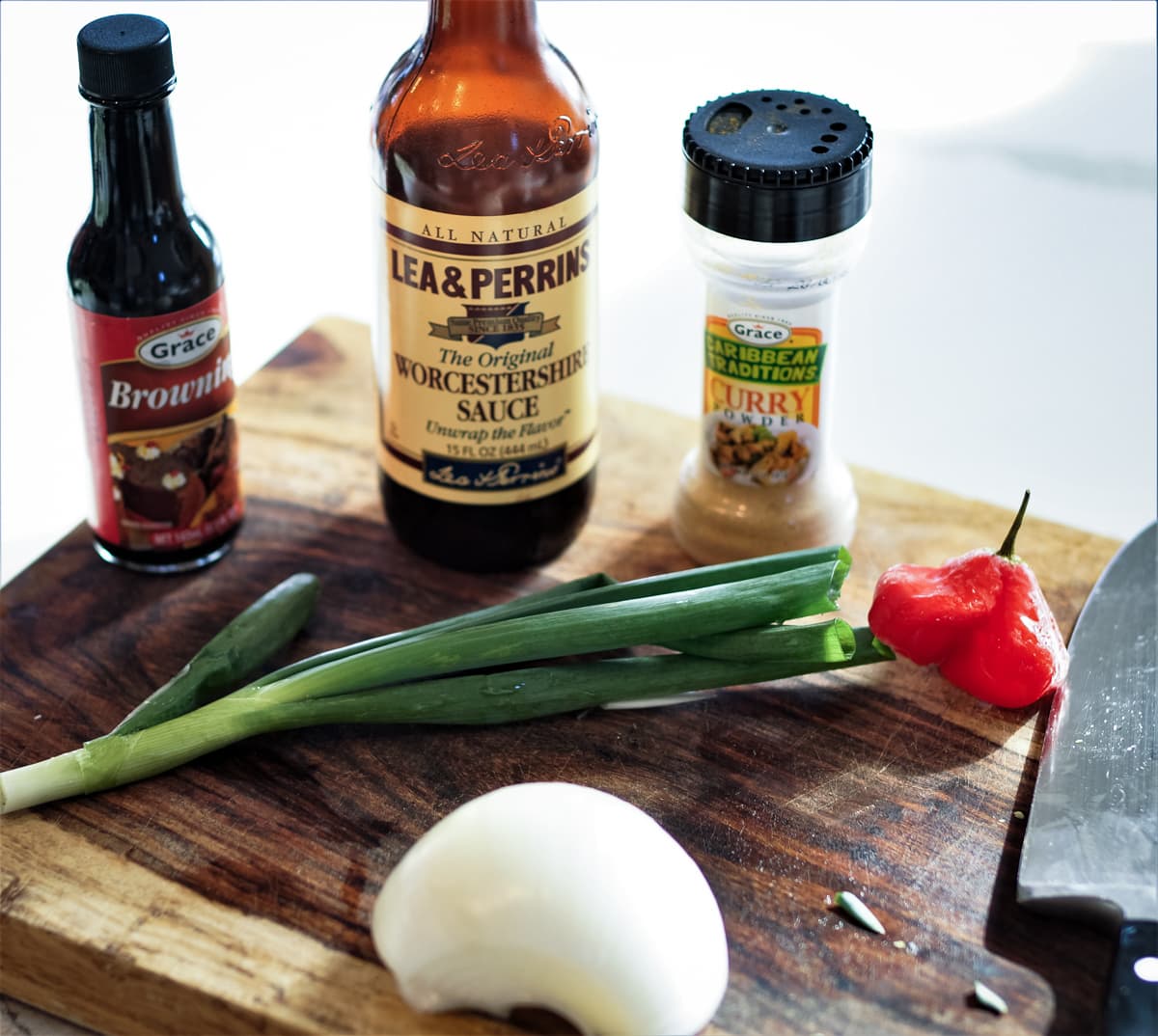 Assorted ingredients on a cutting board for oxtail stew.