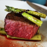 Filet of teres major served with asparagus and a wine sauce.