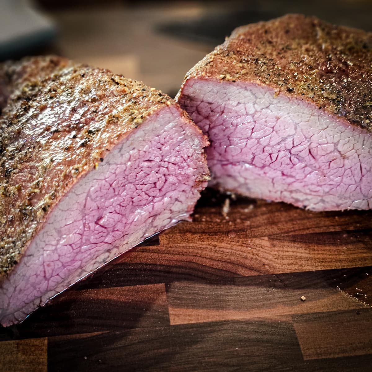 Medium rare tri tip roast on a cutting board.