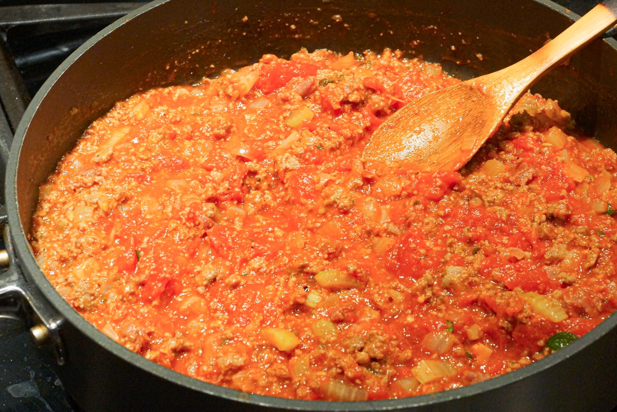 Sausage pasta sauce simmering in a pan.