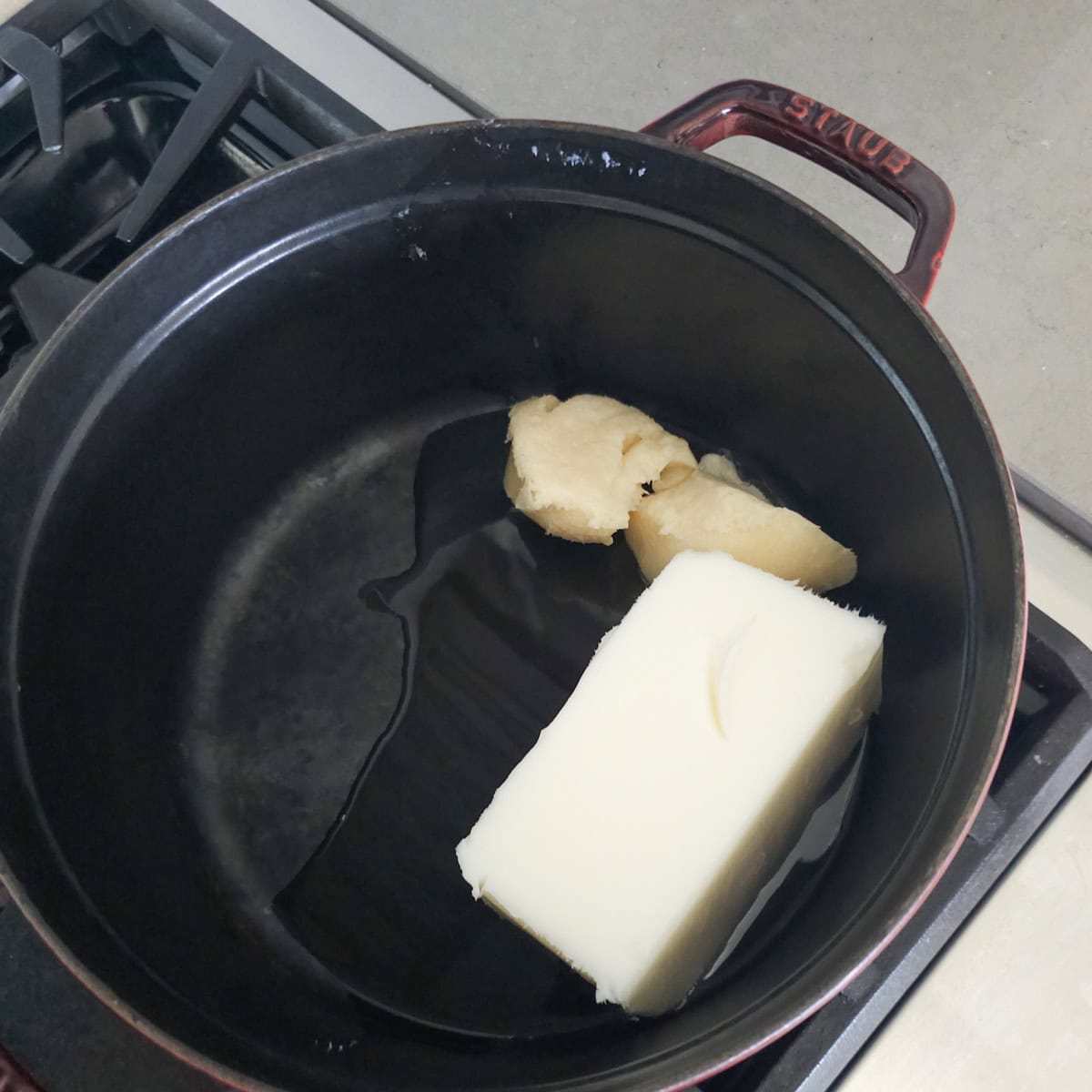 Lard and bacon fat in a Dutch oven.