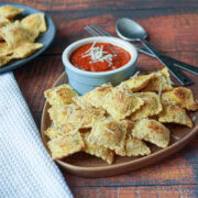 Plate of toasted ravioli with marinara sauce.