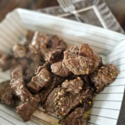 Container of garlic butter steak bites of Brazilian steak seasoning.