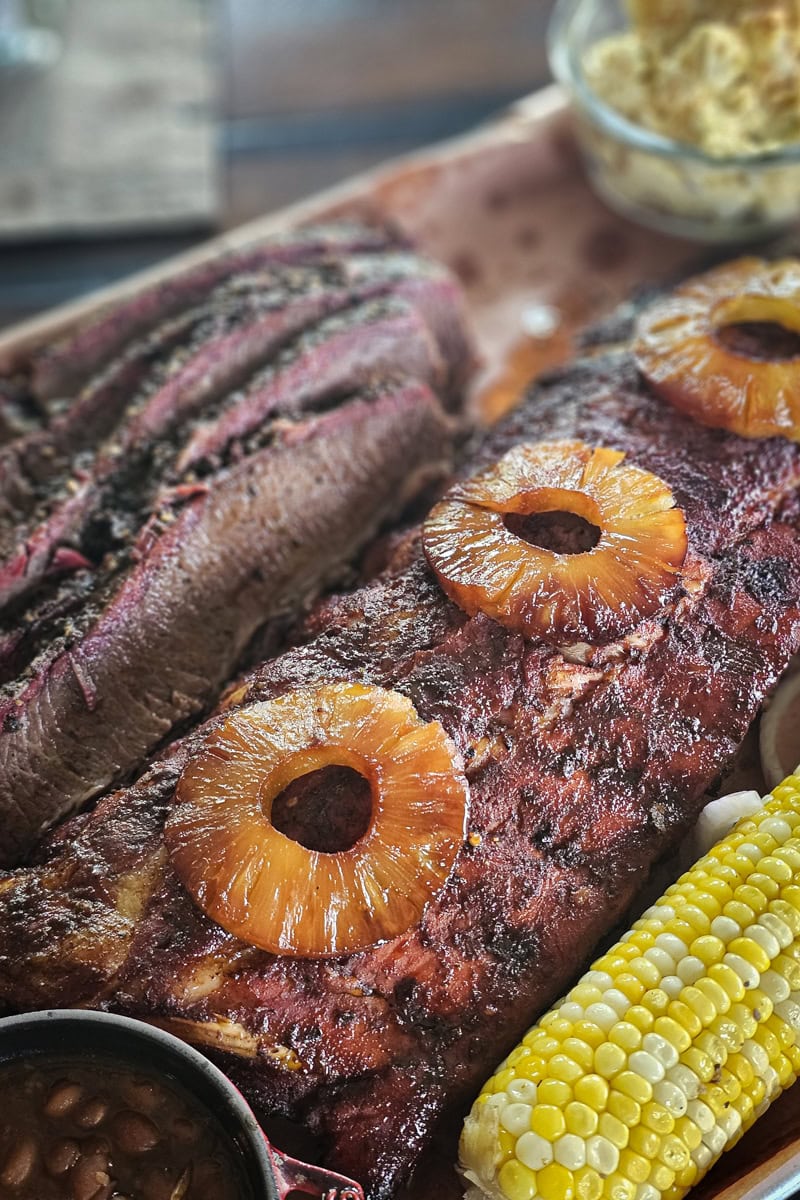 Smoked al Pastor style ribs topped with pineapple, on a BBQ platter.
