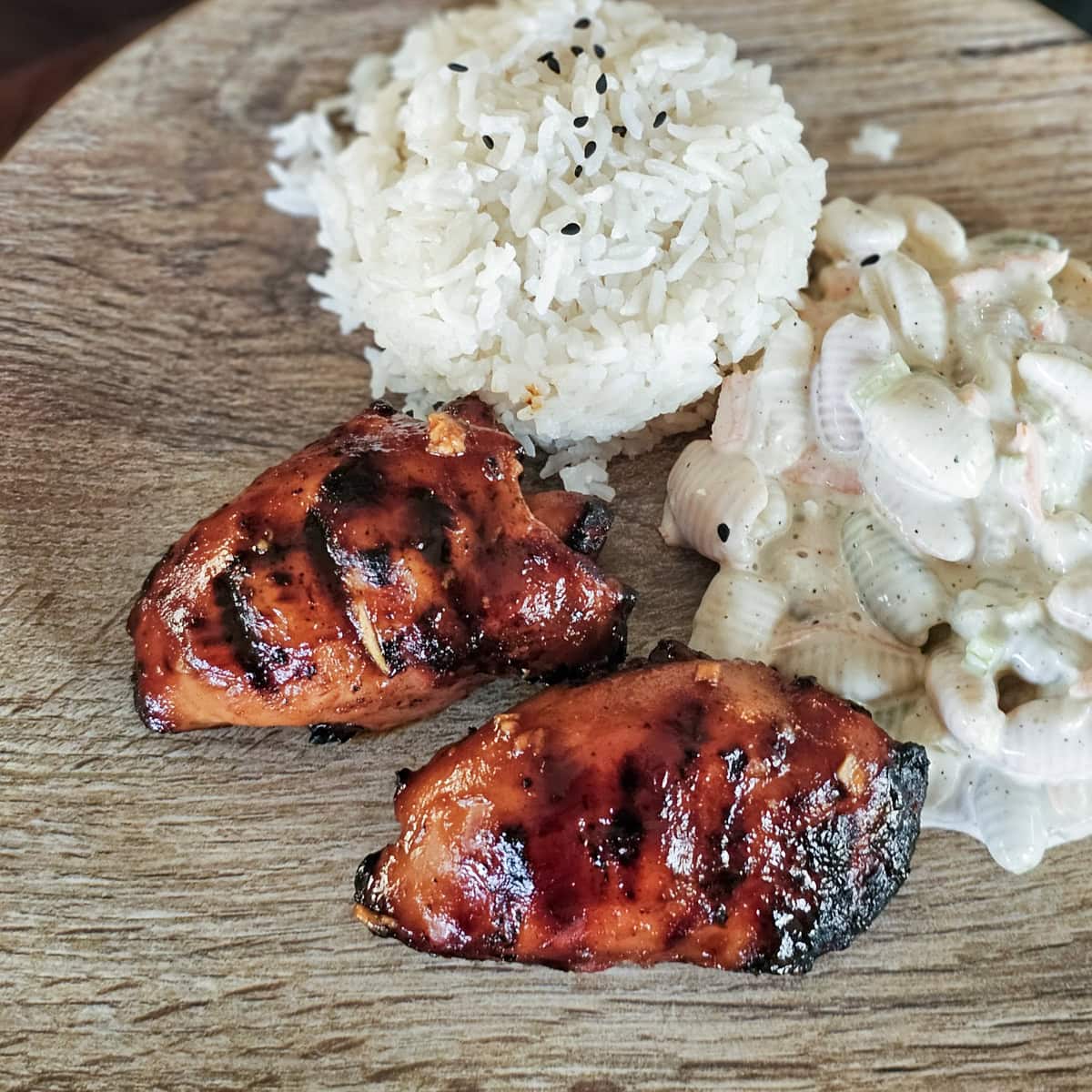 Charcoal grilled Hawaiian Huli Huli chicken with white rice and macaroni salad.