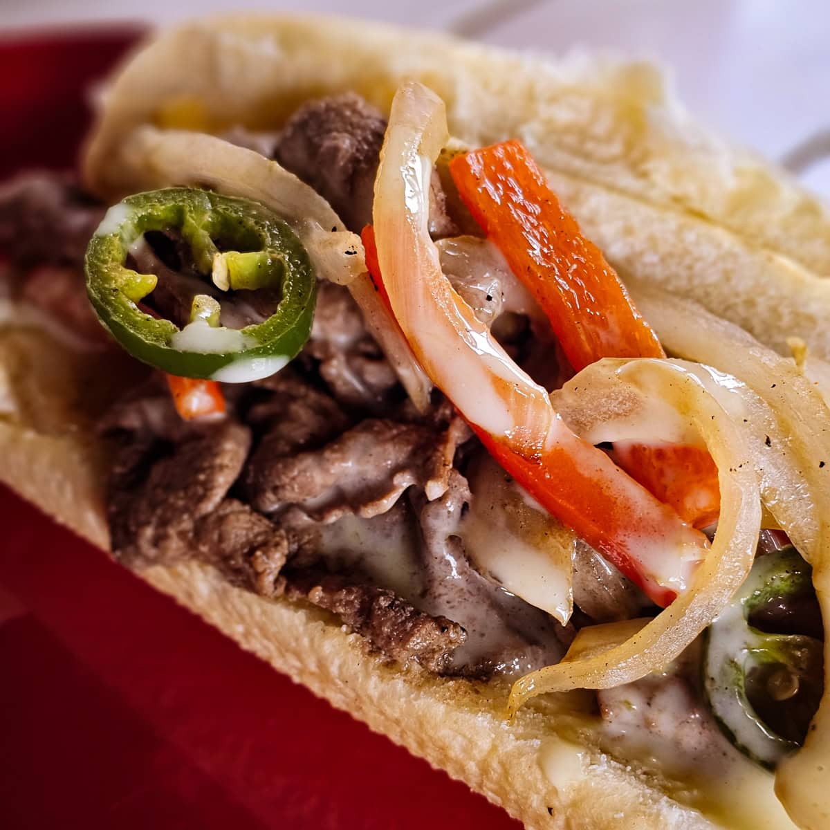 Mexican cheesesteak with carne asada, peppers, and queso.