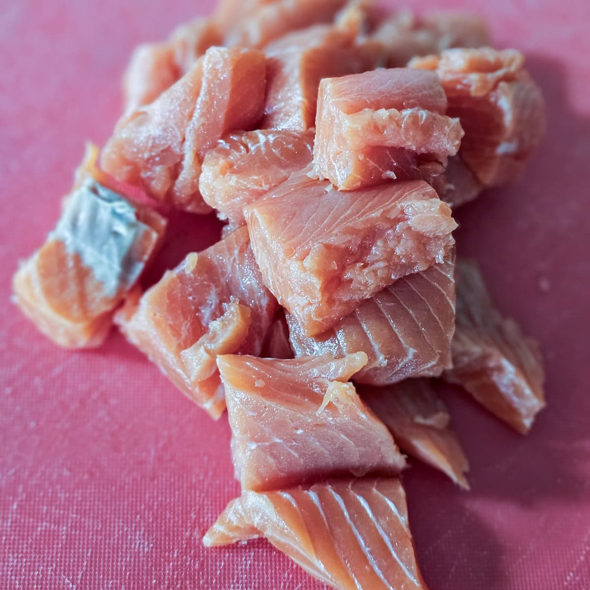 Salmon cut into bite sized chunks.