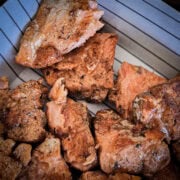 Blackened Cajun salmon bites cooked on a Blackstone.