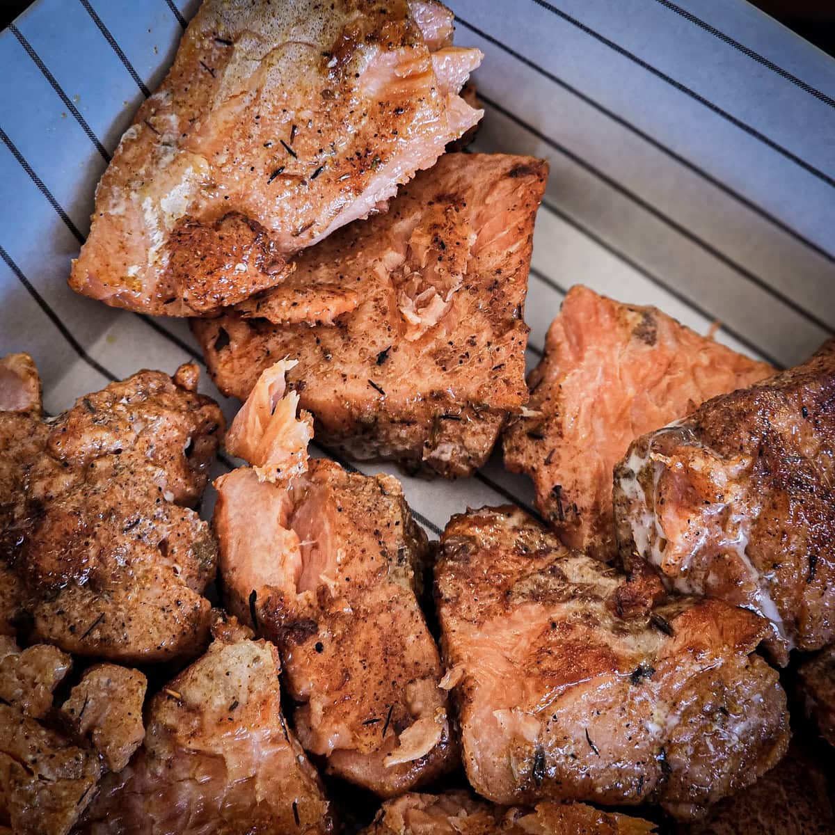 Blackened Cajun salmon bites cooked on a Blackstone.