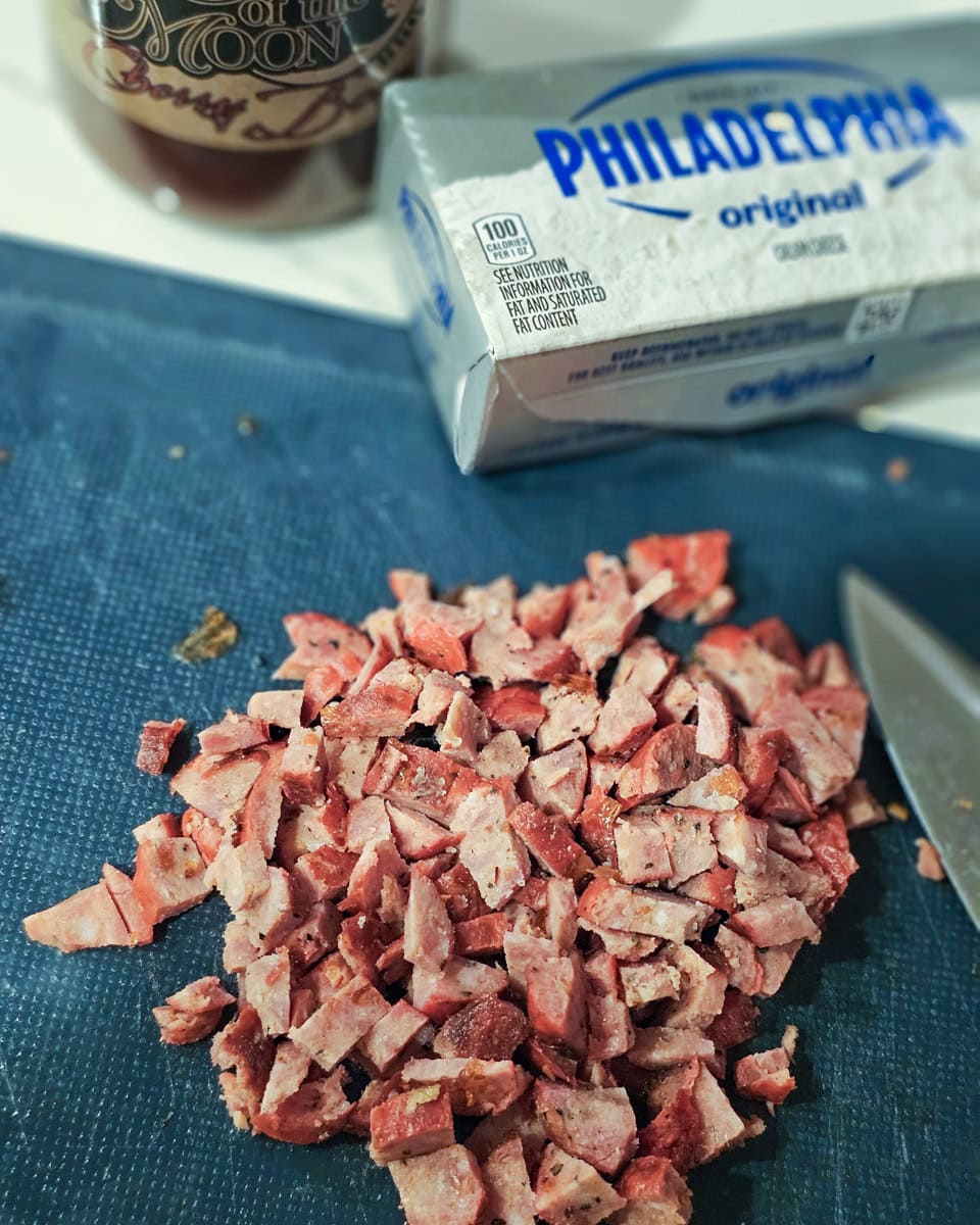 Diced hot link sausages and a block of cream cheese.