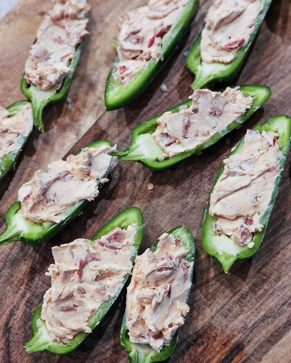 Jalapeno halves stuffed with cream cheese, hot link sausage, and BBQ sauce.
