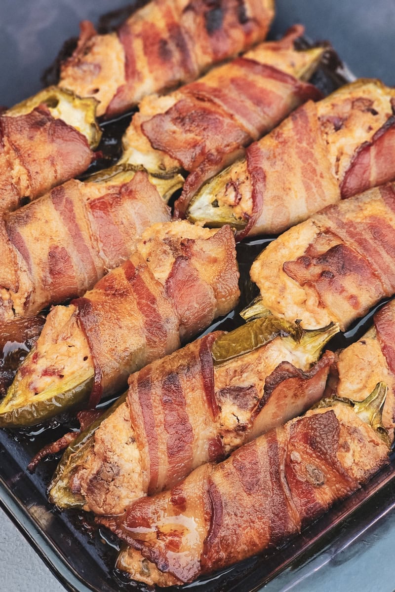 Bacon wrapped jalapenos stuffed with cream cheese and hot links.