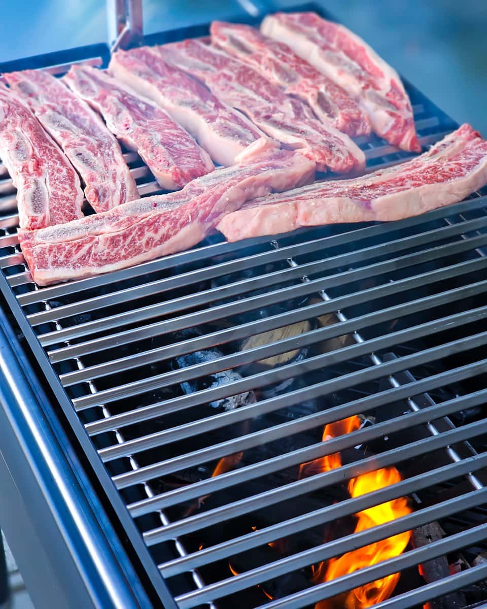 Asado style beef short ribs cooking over charcoal and hardwood.