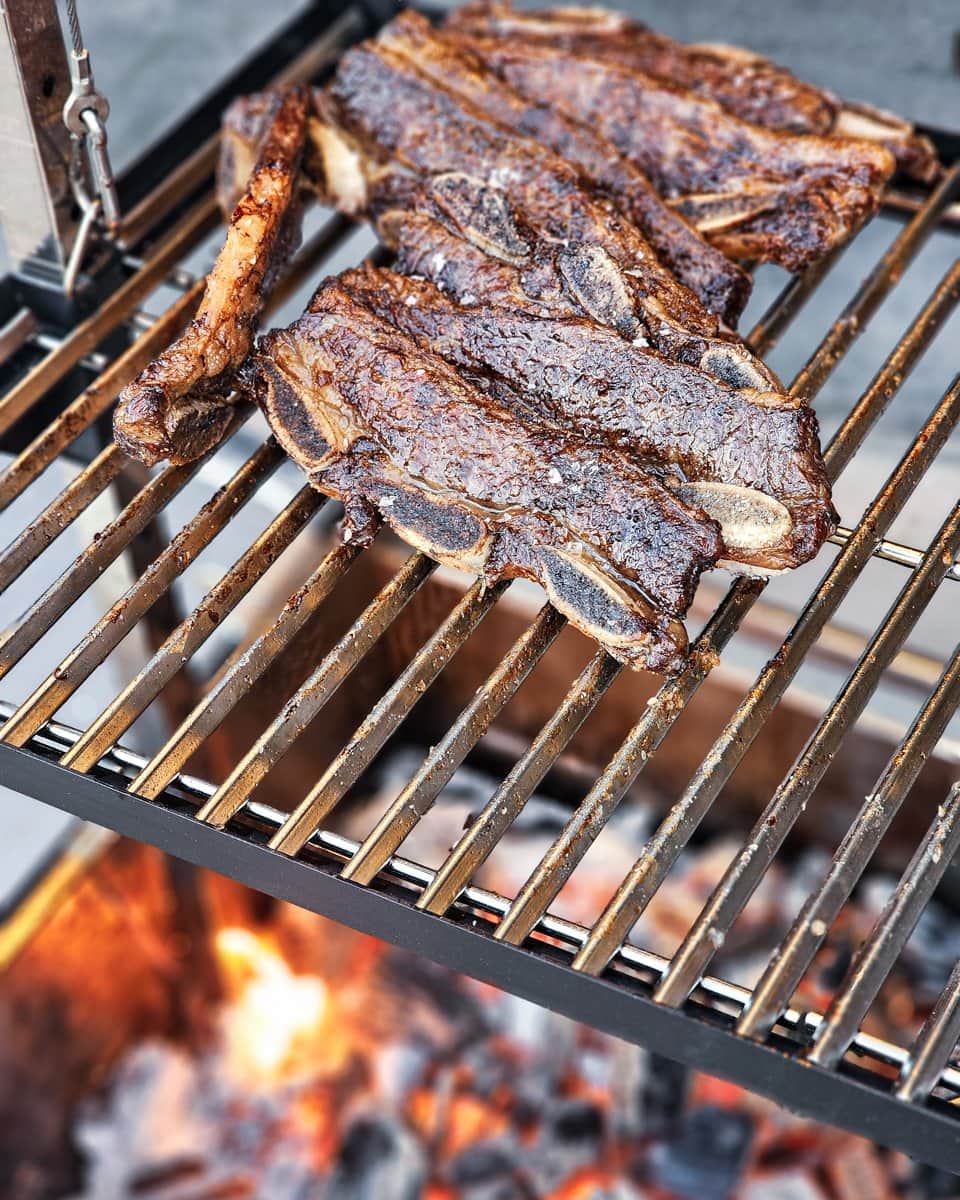 Argentinian style beef short ribs on a grill.