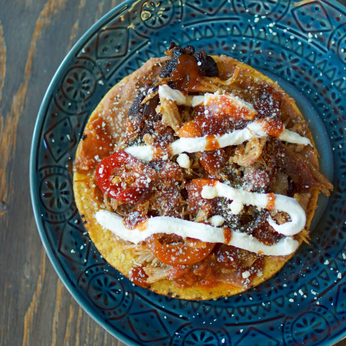 Tostada style pulled pork tacos.