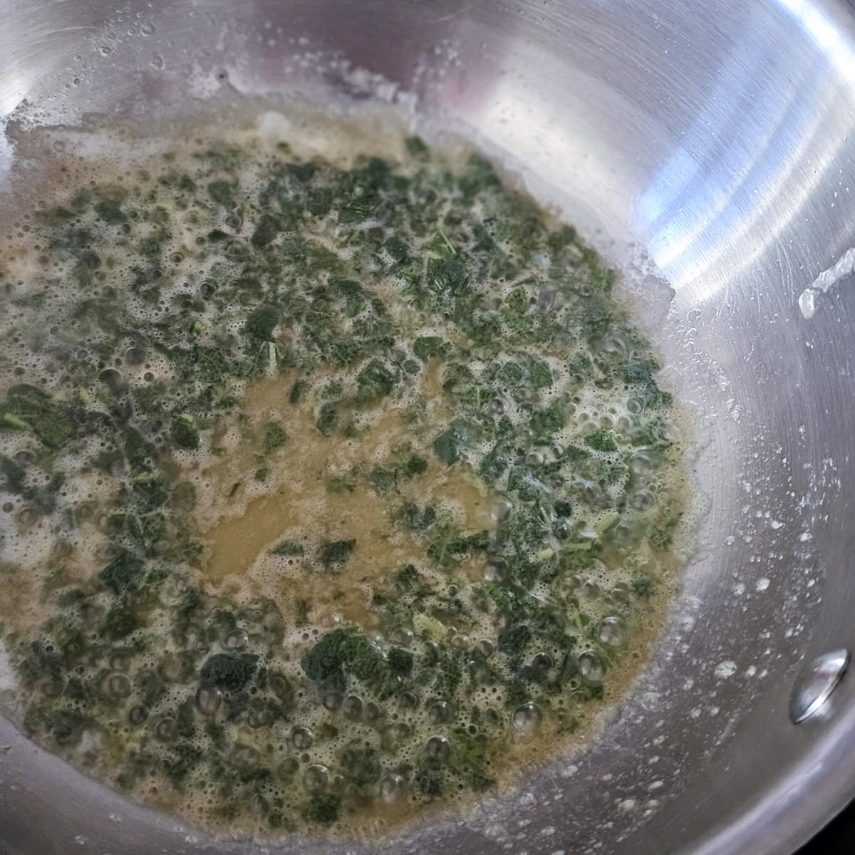 Brown butter with sage in a sauce pan.