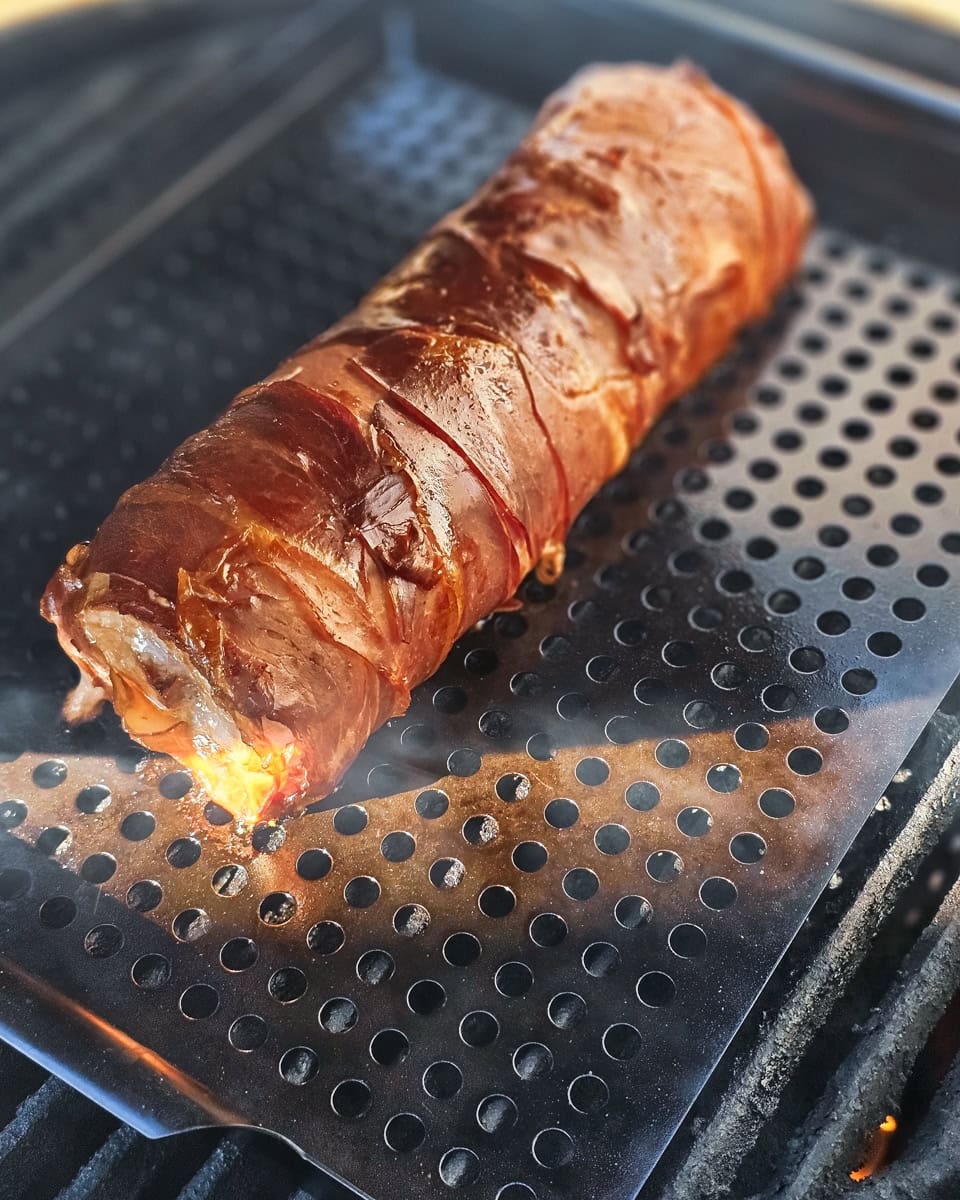 Smoking a prosciutto wrapped stuffed pork loin on a Big Green Egg smoker.