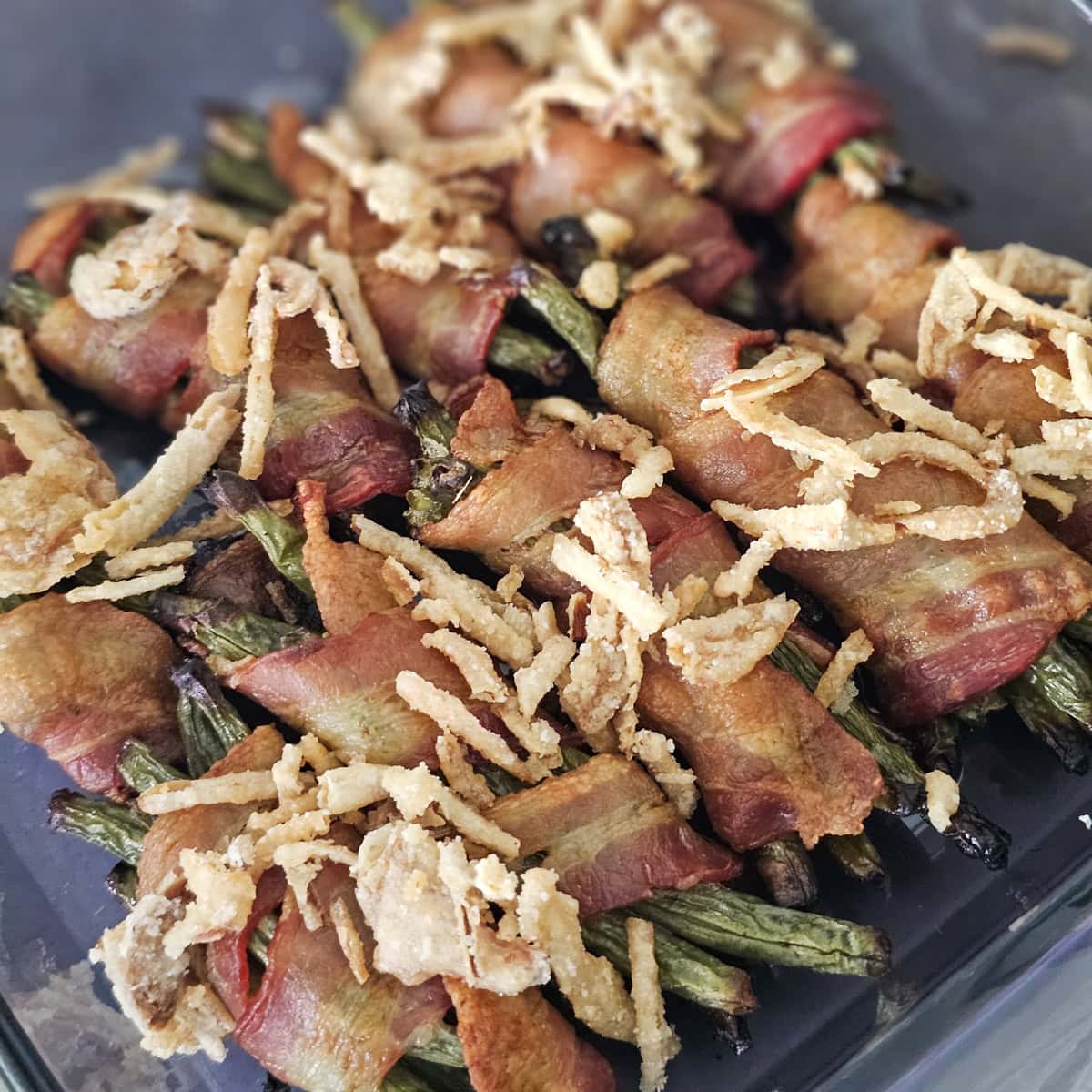 Bacon wrapped green beans topped with fried onions.